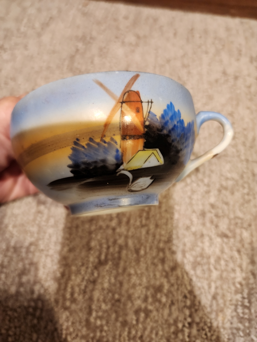 Hand-Painted Ceramic Teacup with Blue and Yellow Landscape Motif